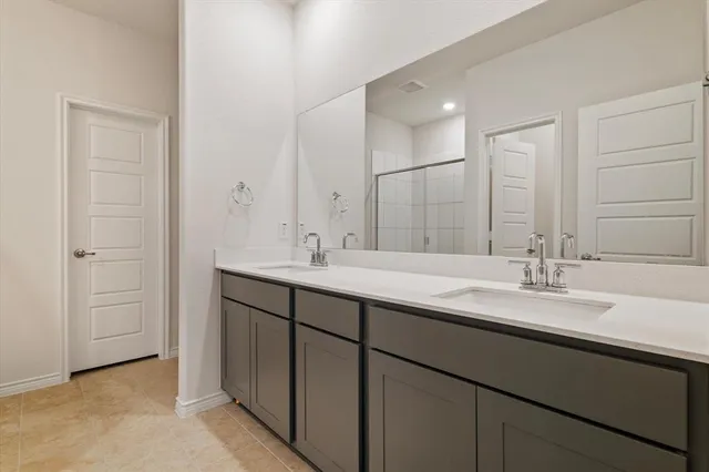a bathroom with a double vanity sink and a mirror