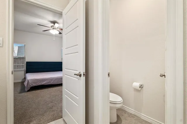 a bathroom with a toilet a sink and view