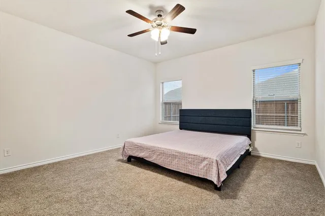 a bedroom with a bed and window