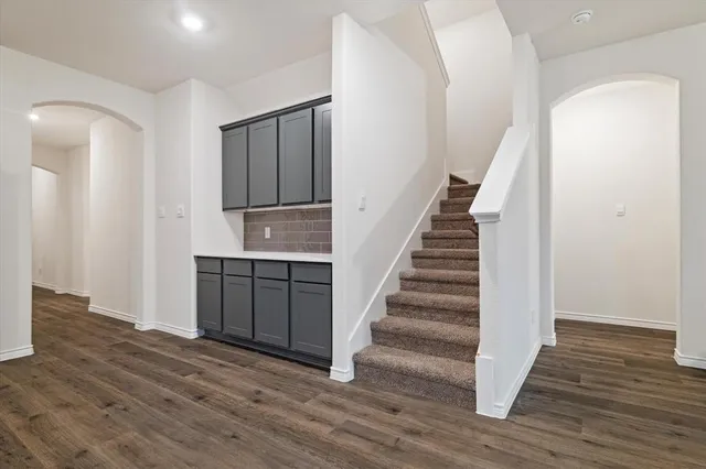 a view of entryway with wooden floor and stairs