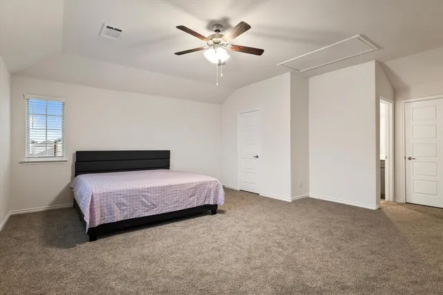 a bedroom with a bed and a ceiling fan