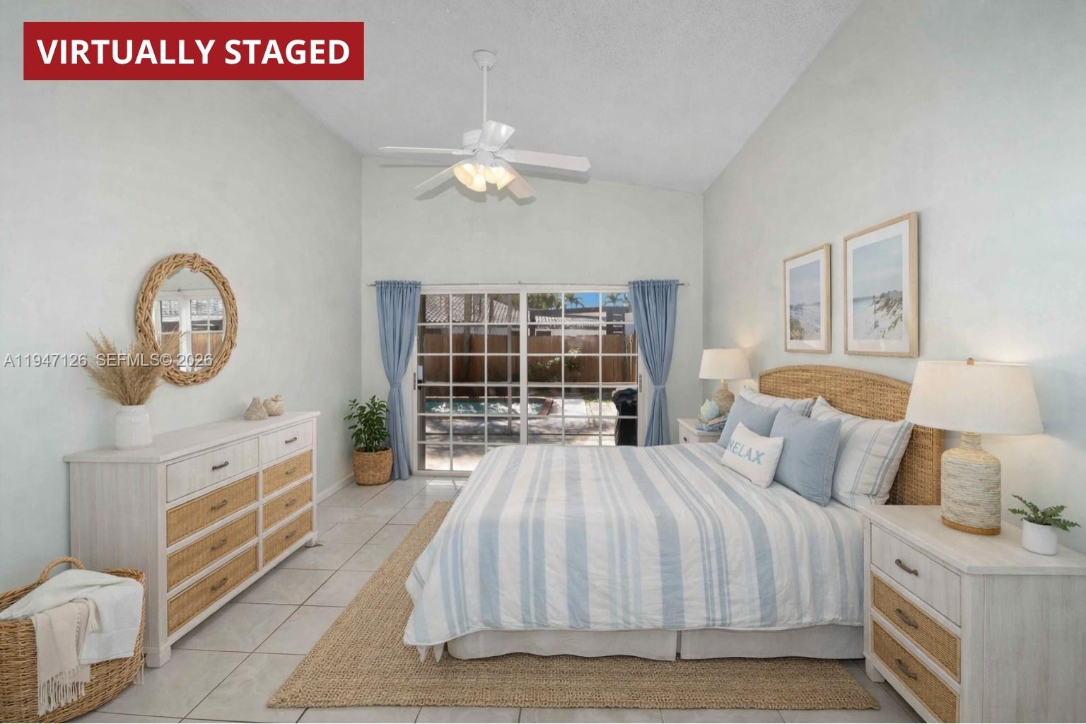 14826 Southwest 110th Terrace Miami, FL 33196 - Photo 12 of 40 a bedroom with a large bed a chandelier and dresser