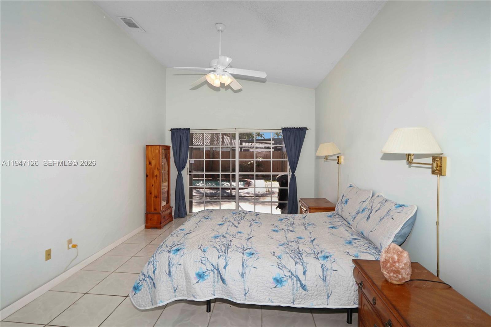 14826 Southwest 110th Terrace Miami, FL 33196 - Photo 13 of 40 a bed sitting in a bedroom next to a window