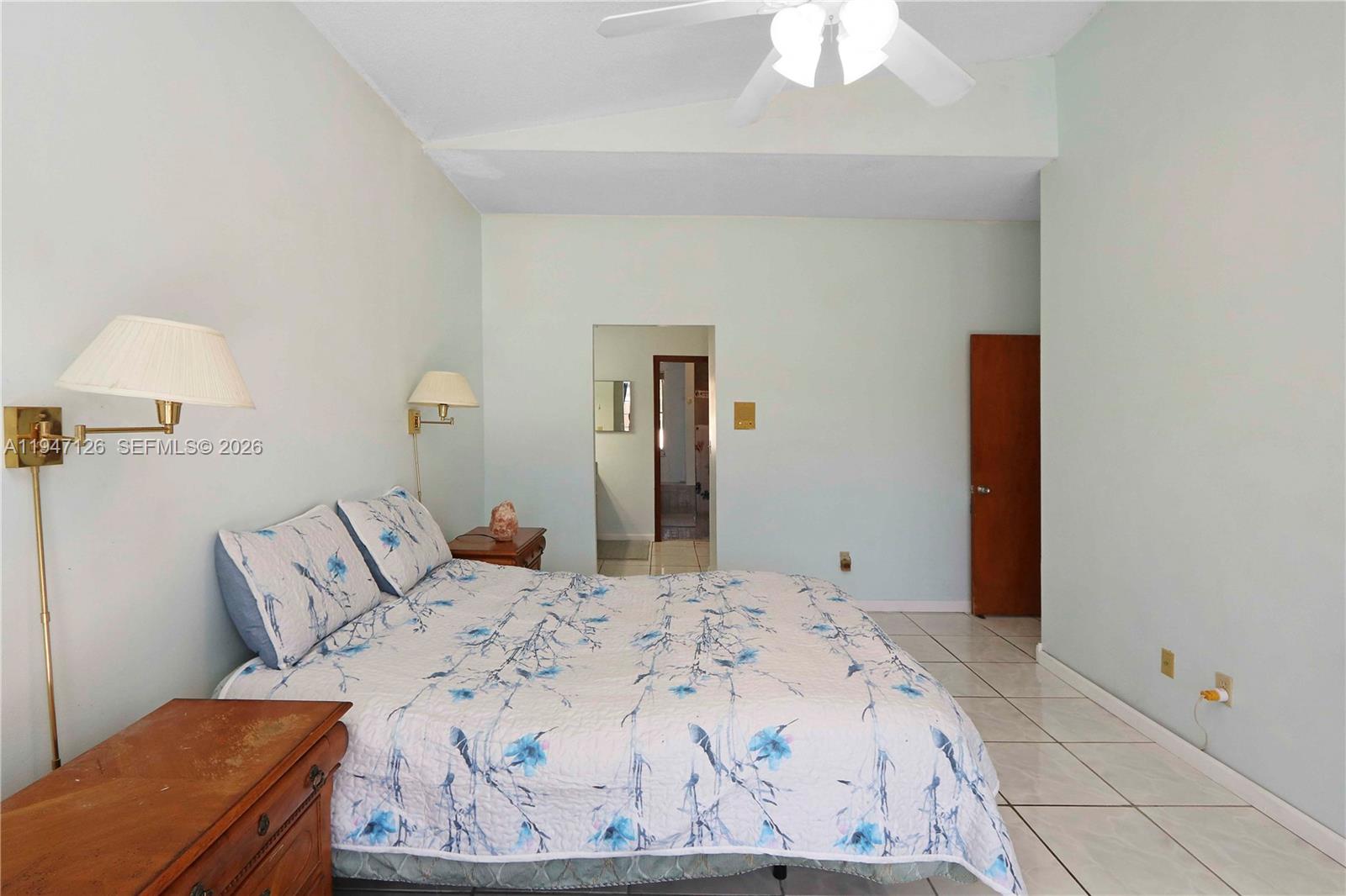 14826 Southwest 110th Terrace Miami, FL 33196 - Photo 14 of 40 a bedroom with a bed and a chandelier