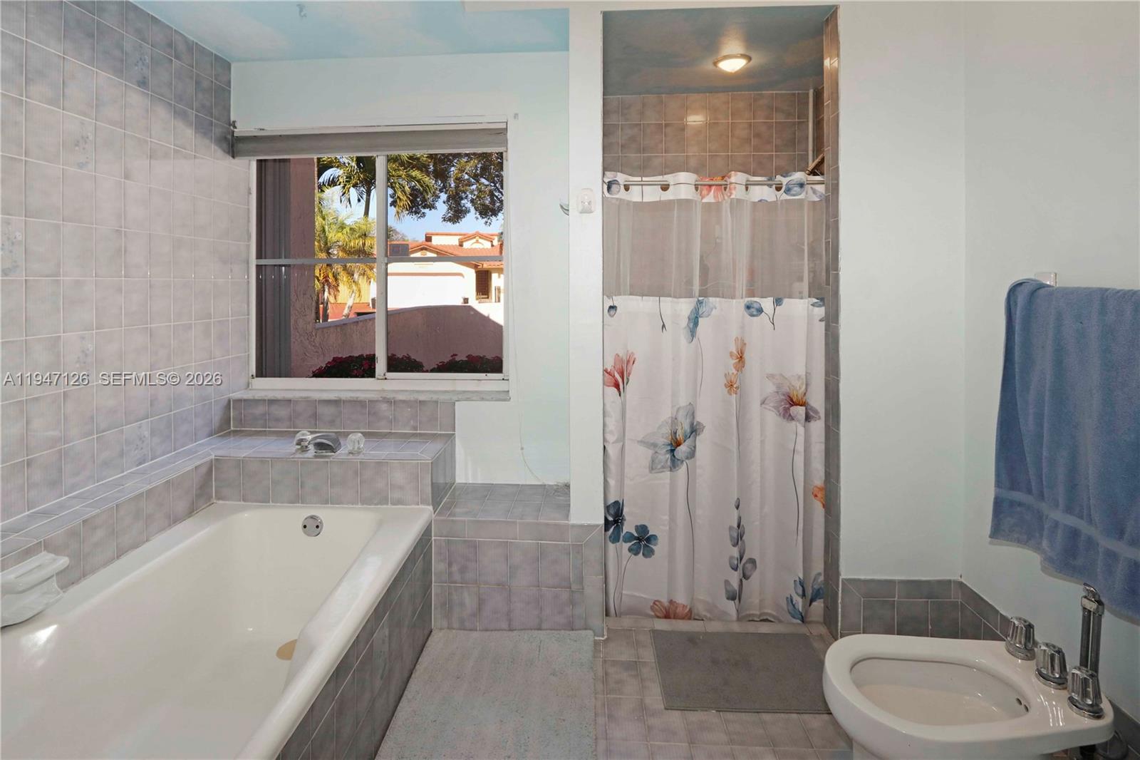 14826 Southwest 110th Terrace Miami, FL 33196 - Photo 16 of 40 a bathroom with a tub sink and mirror