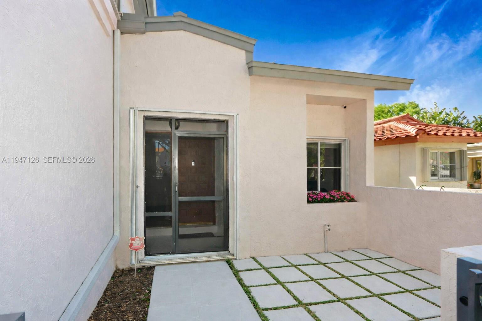 14826 Southwest 110th Terrace Miami, FL 33196 - Photo 2 of 40 a view of a entryway door of the house