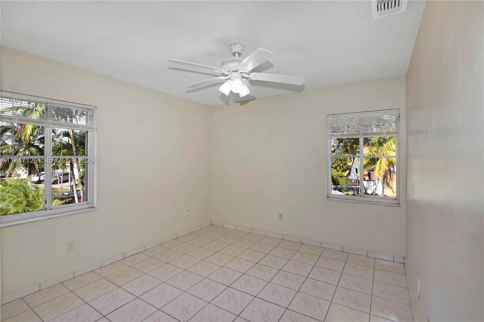 14826 Southwest 110th Terrace Miami, FL 33196 - Photo 21 of 40 an empty room with windows and fan