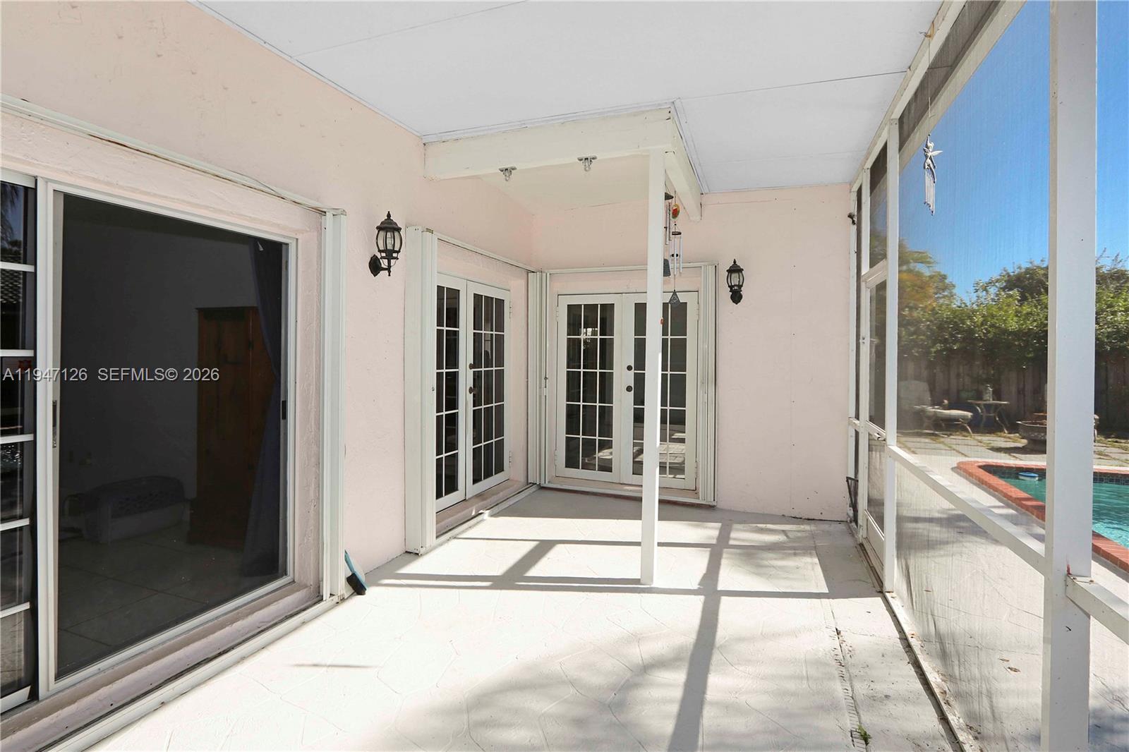 14826 Southwest 110th Terrace Miami, FL 33196 - Photo 26 of 40 a view of a balcony with wooden floor and glass door