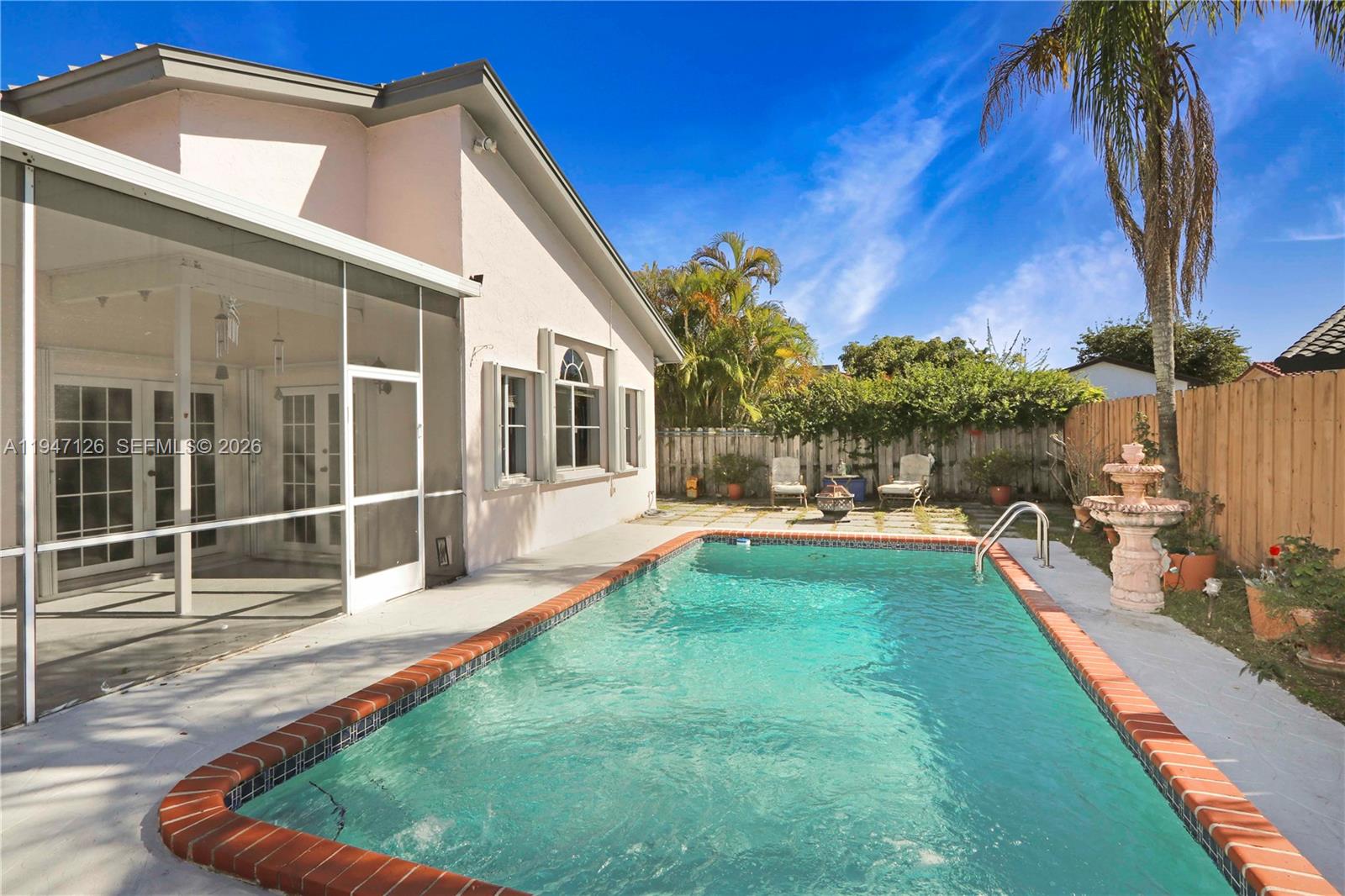 14826 Southwest 110th Terrace Miami, FL 33196 - Photo 27 of 40 a swimming pool with outdoor seating and yard
