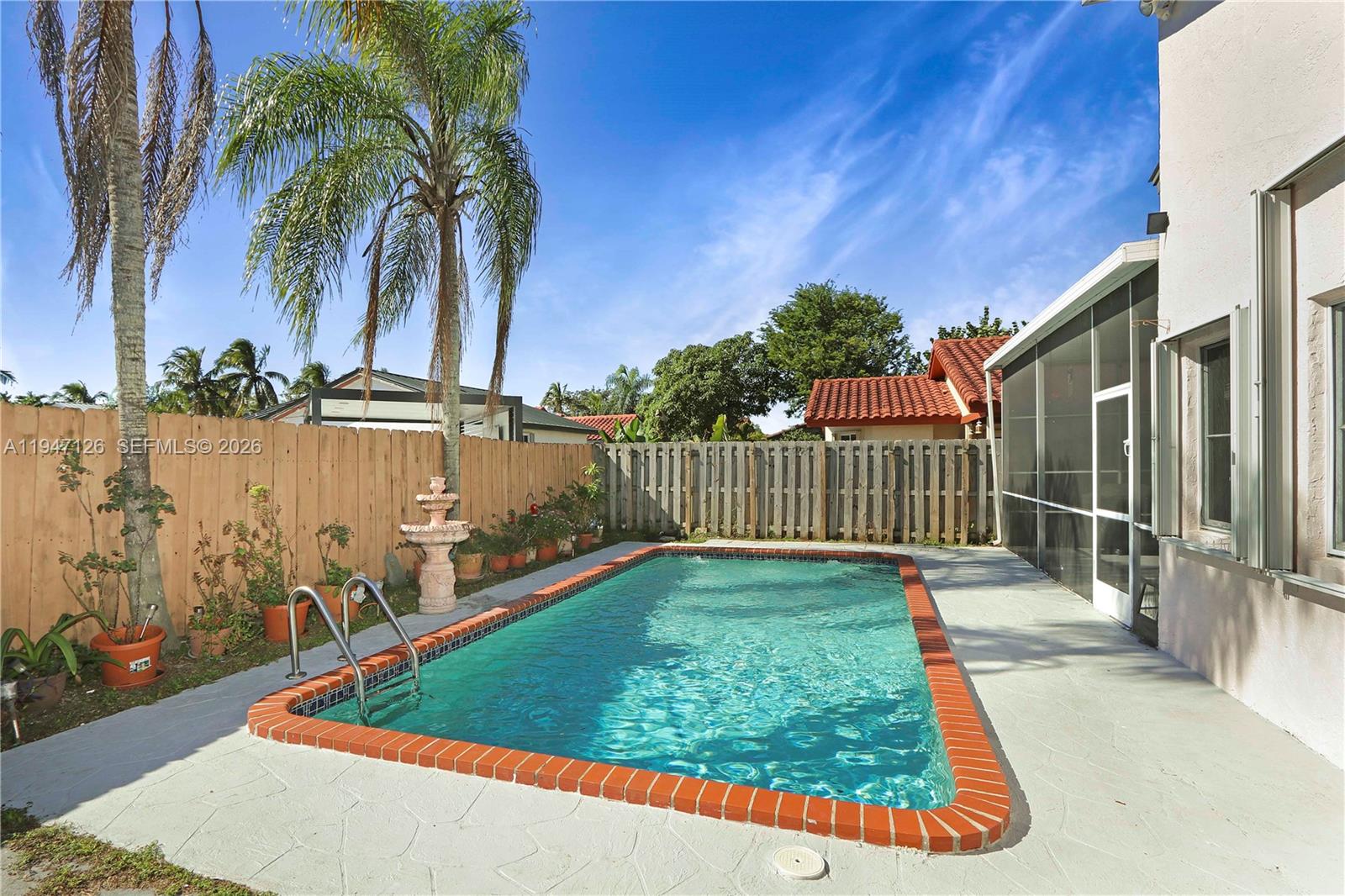 14826 Southwest 110th Terrace Miami, FL 33196 - Photo 29 of 40 a view of a backyard with swimming pool