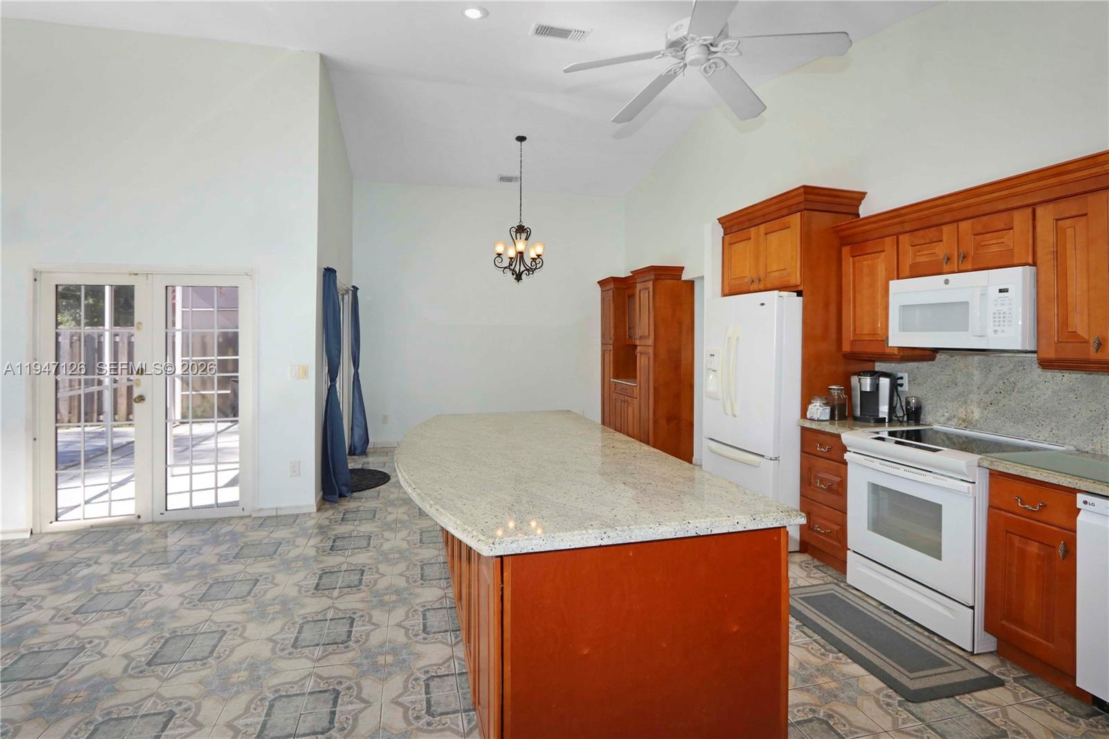 14826 Southwest 110th Terrace Miami, FL 33196 - Photo 10 of 40 a kitchen with stainless steel appliances granite countertop a refrigerator a stove and a sink