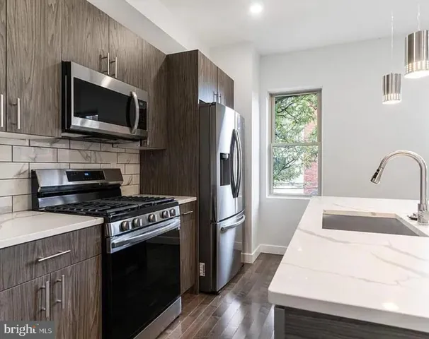 a kitchen with a stove a microwave and a refrigerator