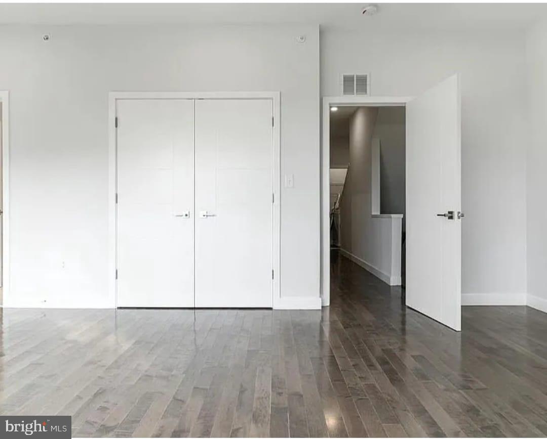 1945 North 7th Street, Unit 3 Philadelphia, PA 19122 - Photo 19 of 22 a view of an empty room with wooden floor and closet