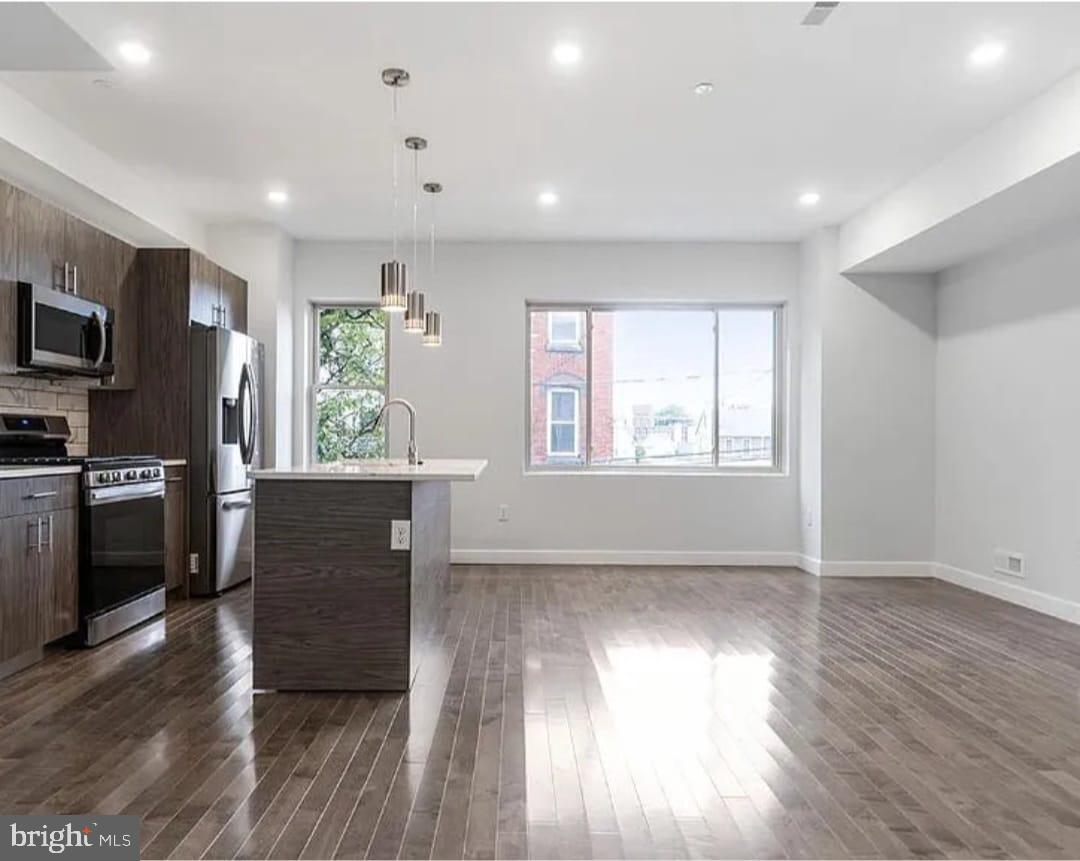 1945 North 7th Street, Unit 3 Philadelphia, PA 19122 - Photo 2 of 22 a view of an empty room with a window and wooden floor