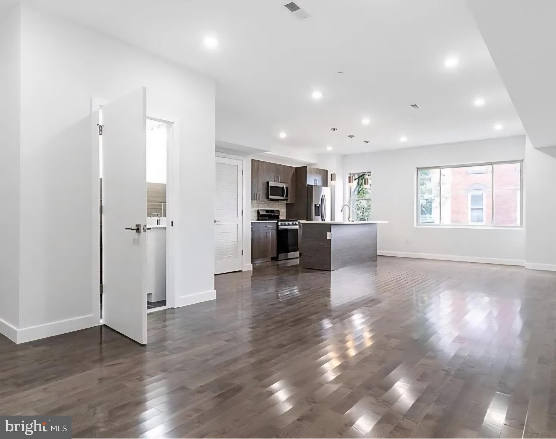 1945 North 7th Street, Unit 3 Philadelphia, PA 19122 - Photo 7 of 22 a view of a livingroom with furniture wooden floor and windows