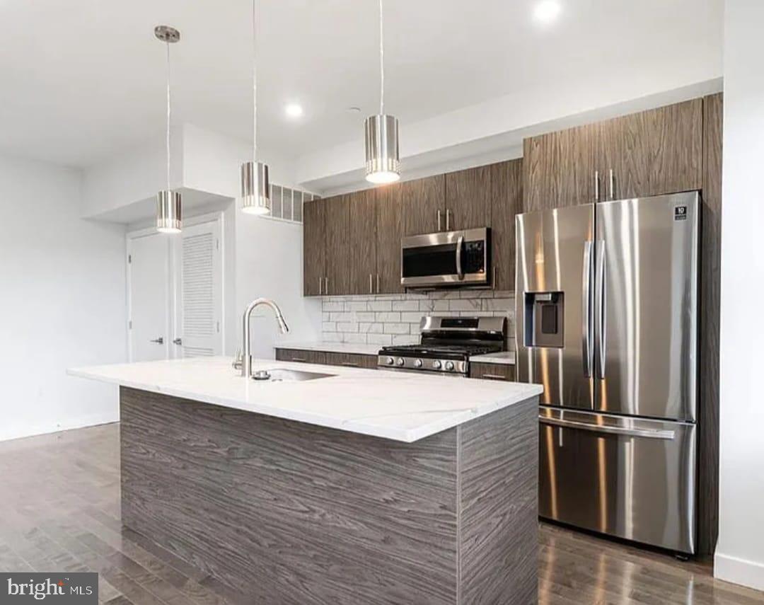 1945 North 7th Street, Unit 3 Philadelphia, PA 19122 - Photo 8 of 22 a kitchen with a refrigerator a sink and microwave