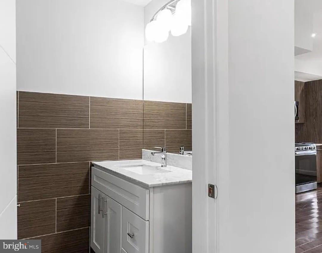 1945 North 7th Street, Unit 3 Philadelphia, PA 19122 - Photo 9 of 22 a bathroom with a sink a mirror and a toilet