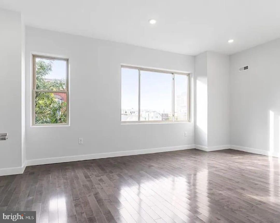 1945 North 7th Street, Unit 3 Philadelphia, PA 19122 - Photo 10 of 22 an empty room with wooden floor and windows