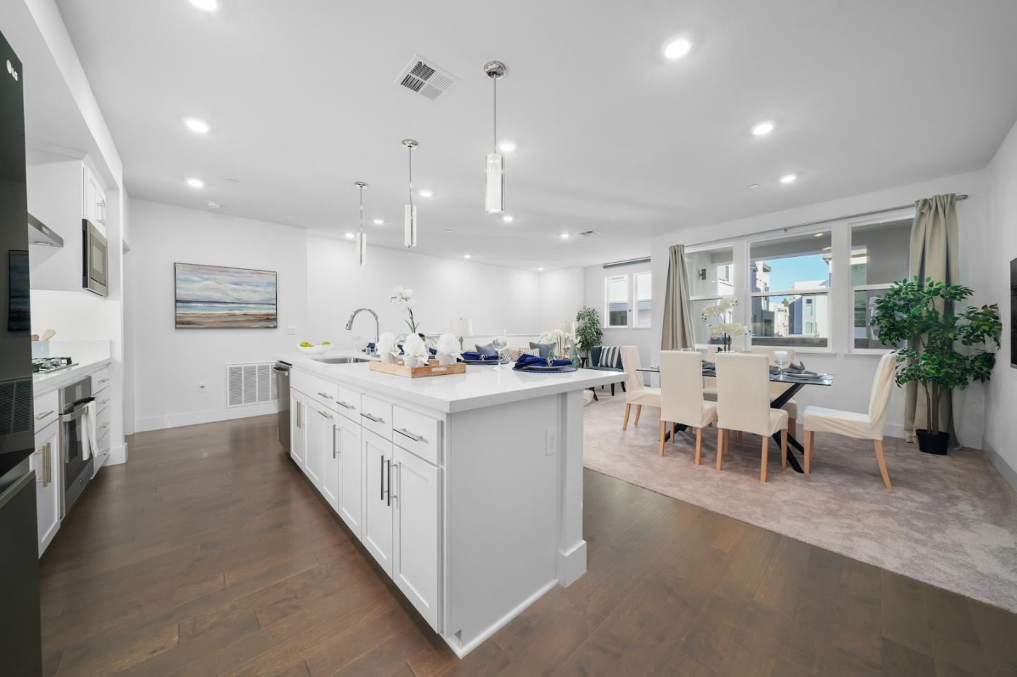 3029 Lamory Place Santa Clara, CA 95051 - Photo 4 of 25 a large white kitchen with lots of counter space a sink appliances and a couch