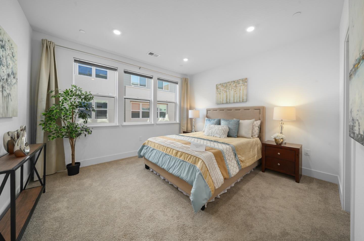 3029 Lamory Place Santa Clara, CA 95051 - Photo 9 of 25 a spacious bedroom with a large bed and a potted plant