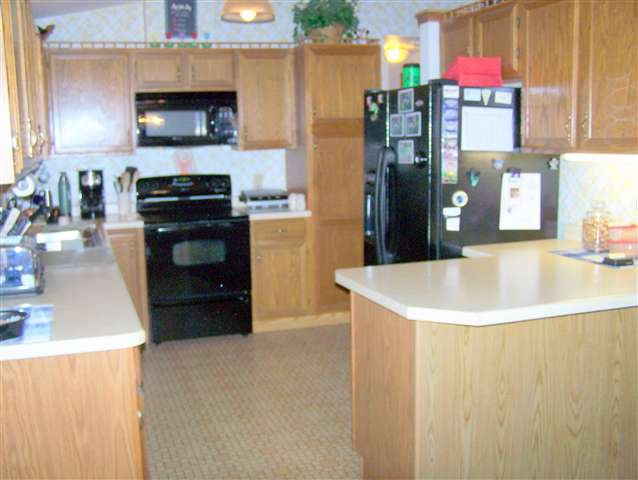 984 Winborne Road Davis, IL 61019 - Photo 2 of 9 a kitchen with stainless steel appliances a stove a microwave and a refrigerator