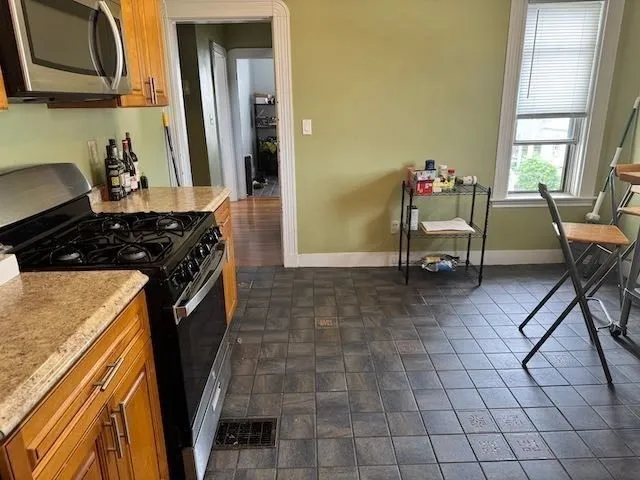 a kitchen with a stove a sink and a refrigerator