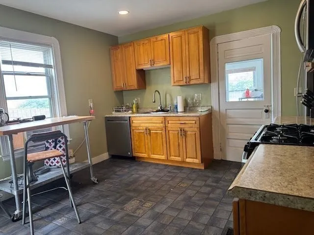 a kitchen with a stove a sink and a refrigerator