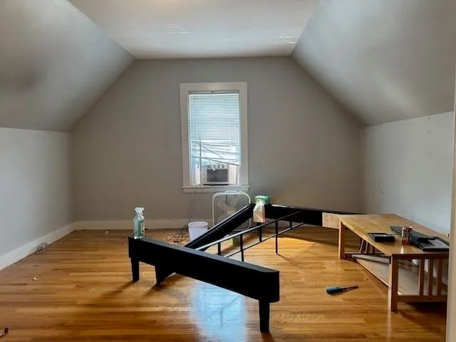 a room with furniture pool table and window