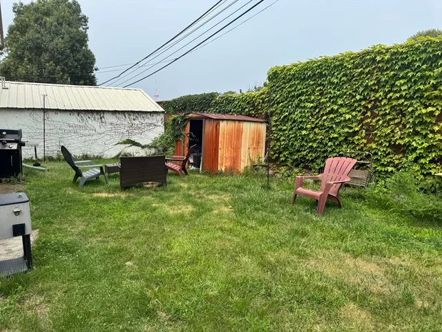 a backyard of a house with table and chairs