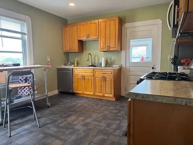 a kitchen with a sink cabinets and a window