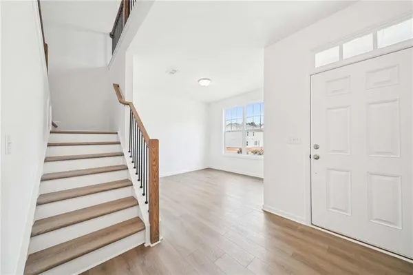 a view of entryway with stairs and wooden floor