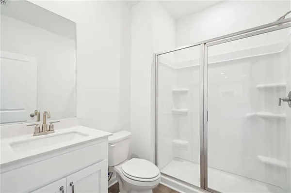 a bathroom with a shower a sink a toilet and shower