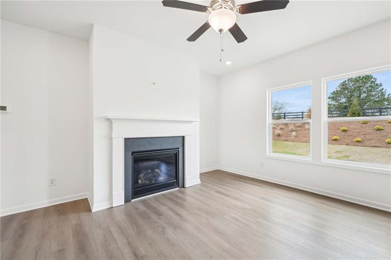 320 Silverleaf Trail Bethlehem, GA 30620 - Photo 3 of 36 an empty room with windows and fireplace