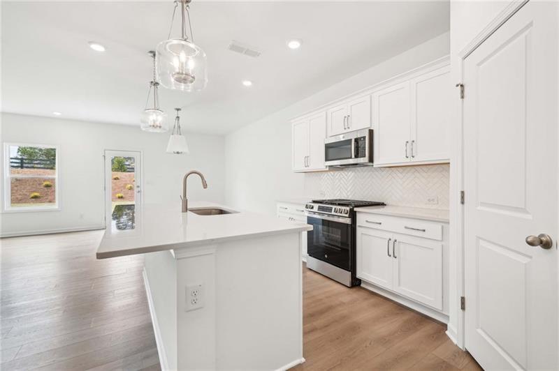 320 Silverleaf Trail Bethlehem, GA 30620 - Photo 5 of 36 a kitchen with stainless steel appliances granite countertop a sink a stove and a refrigerator