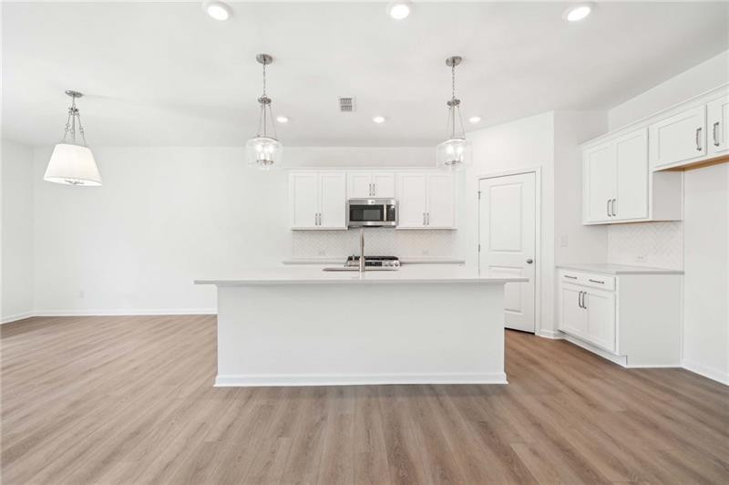 320 Silverleaf Trail Bethlehem, GA 30620 - Photo 6 of 36 a view of kitchen with granite countertop sink and refrigerator