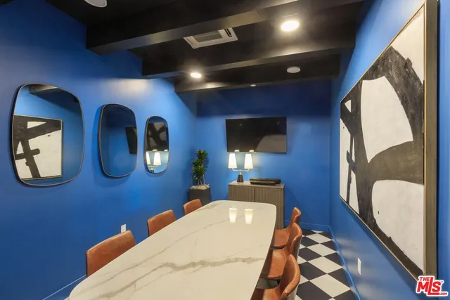 a room with gym equipment and large windows