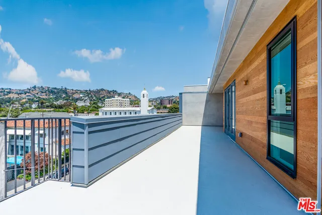 a view of a terrace with wooden floor and city view