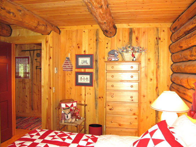 6210 Mountain View Road, Unit 133 Coalville, UT 84017 - Photo 44 of 87 The primary bedroom has log exterior walls and pine paneling interior walls. Most of the furniture in the cabin is from the beautiful Lane, Americana Collection.