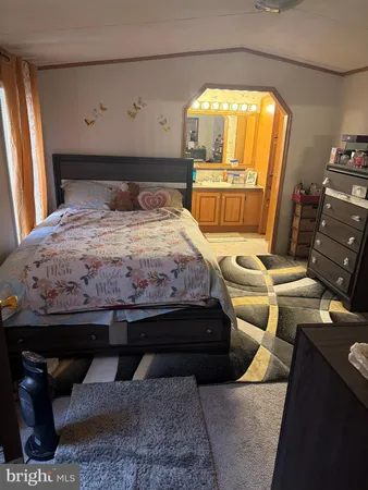 a bedroom with a bed and a mirror