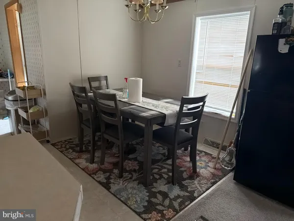 a view of a dining room with furniture and a window