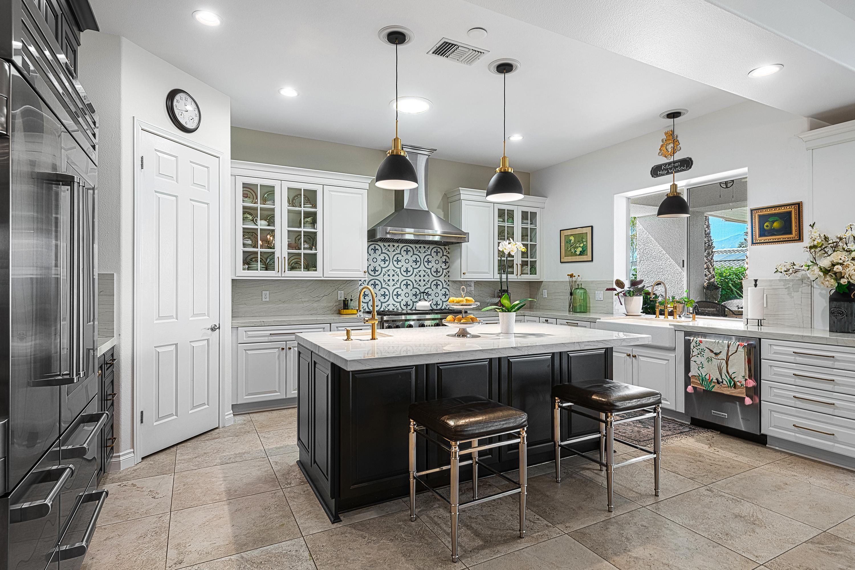 3 Trafalgar Rancho Mirage, CA 92270 - Photo 11 of 42 a kitchen with kitchen island granite countertop lots of counter top space and stainless steel appliances
