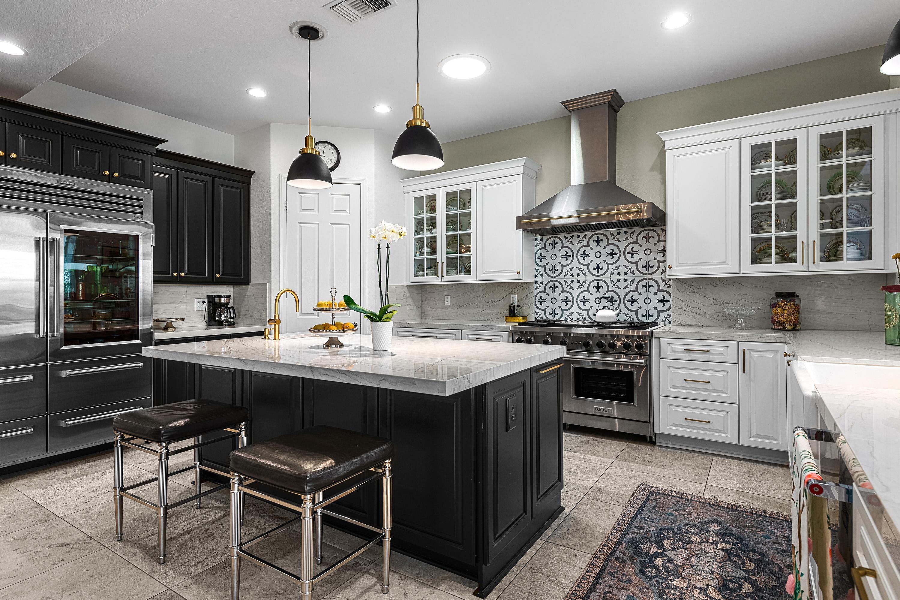 3 Trafalgar Rancho Mirage, CA 92270 - Photo 13 of 42 a kitchen with kitchen island granite countertop a sink and a stove