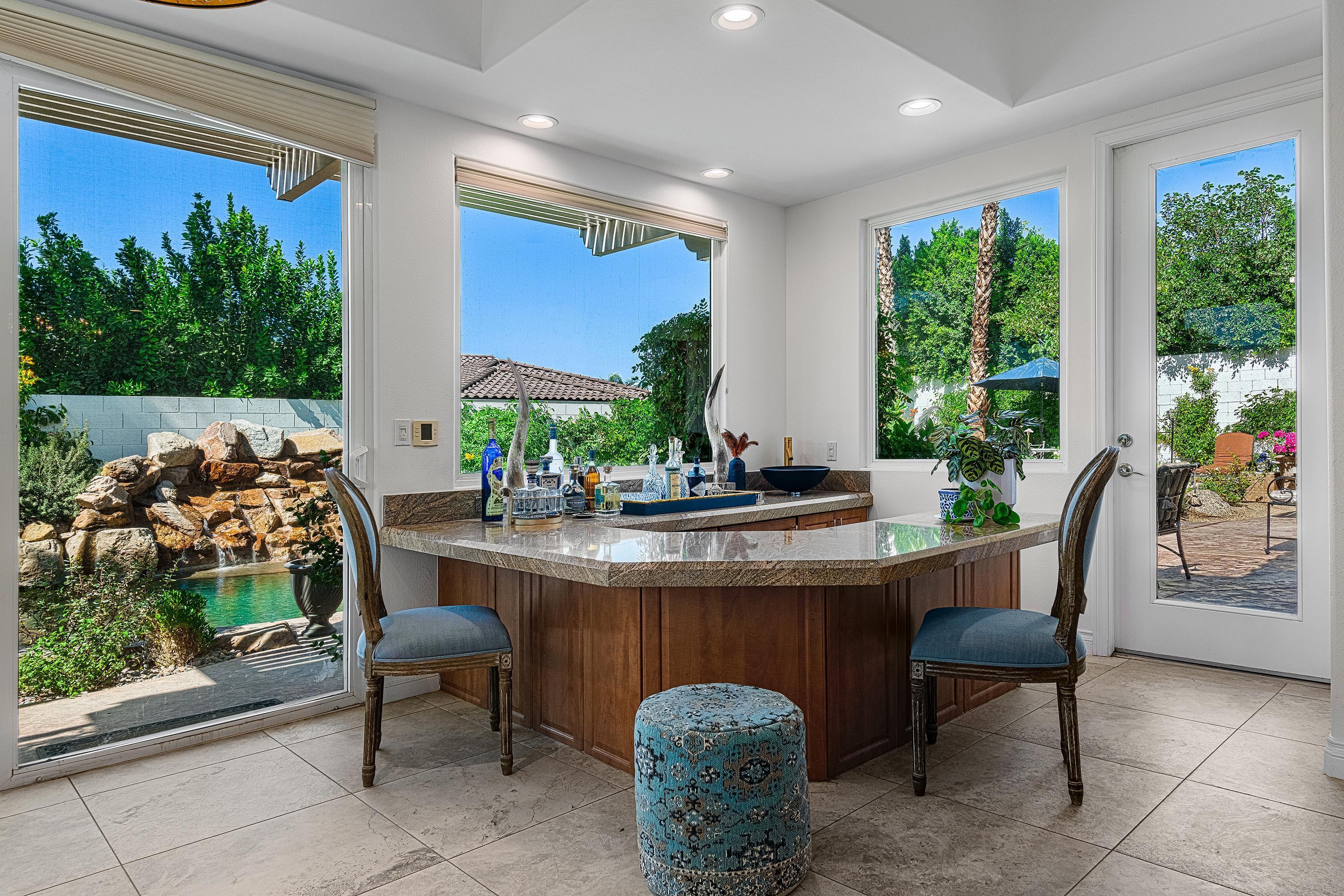 3 Trafalgar Rancho Mirage, CA 92270 - Photo 17 of 42 a dining room with furniture a floor to ceiling window and outdoor view