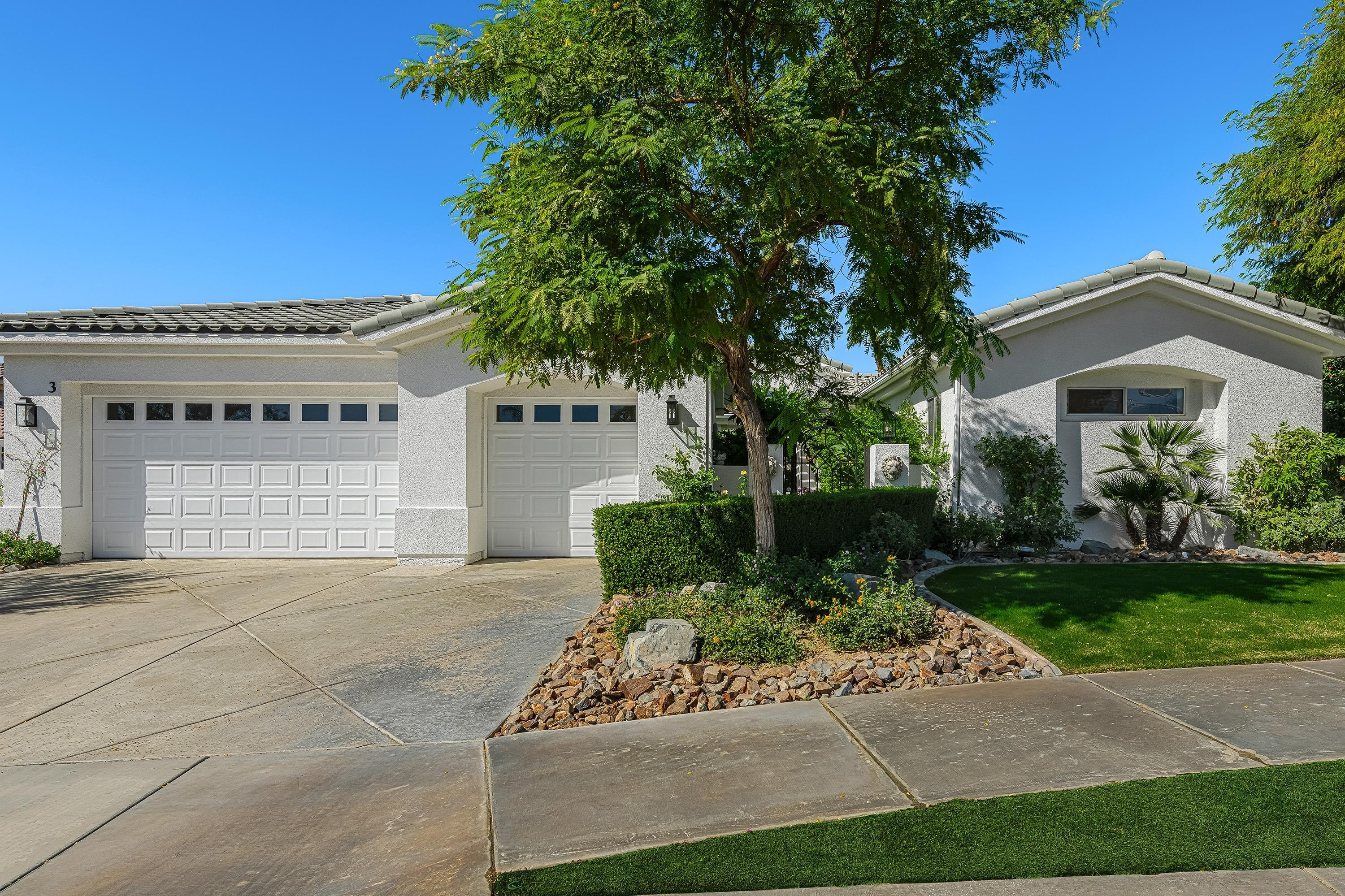 3 Trafalgar Rancho Mirage, CA 92270 - Photo 2 of 42 a front view of a house with a yard and garage