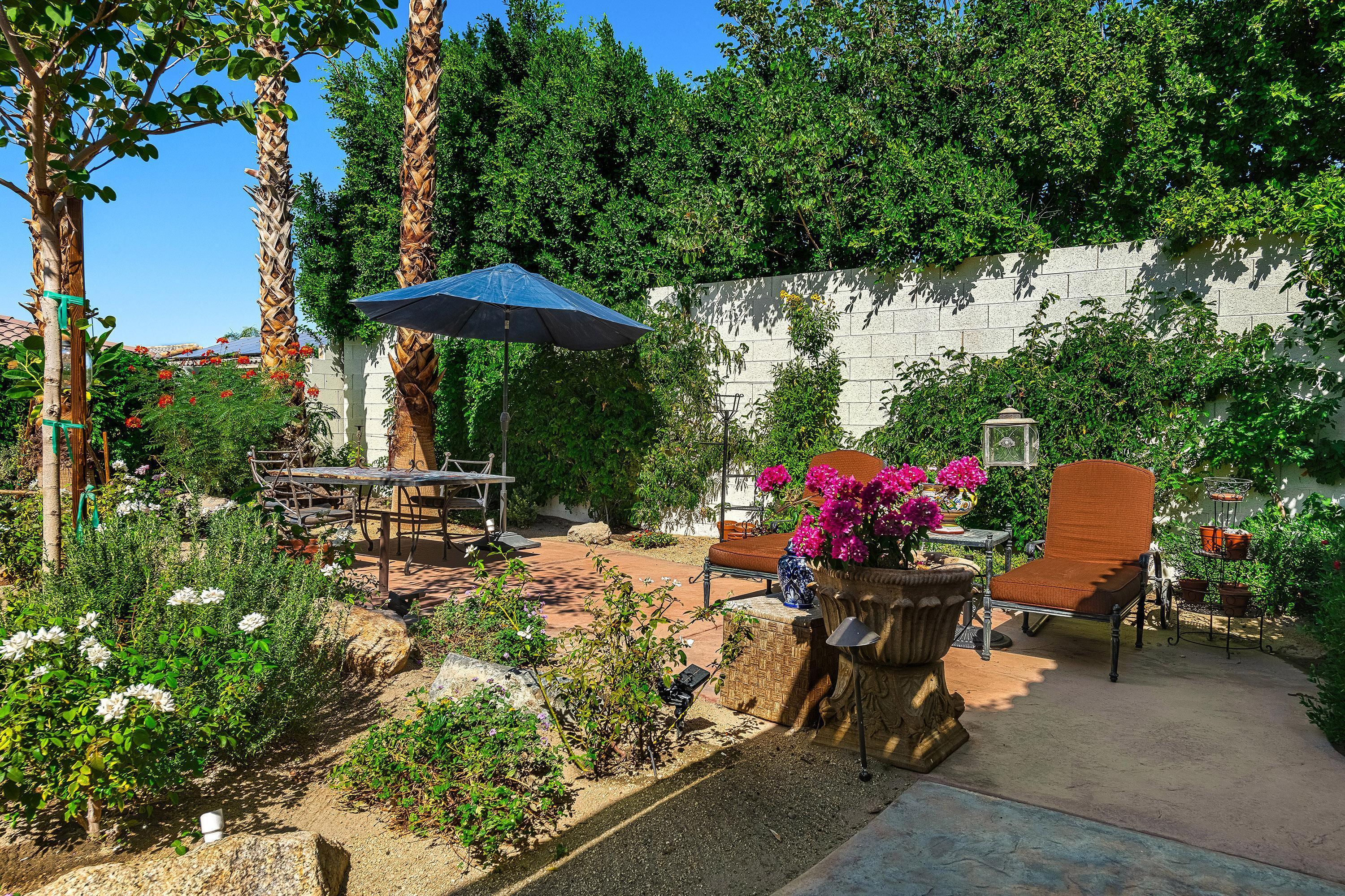 3 Trafalgar Rancho Mirage, CA 92270 - Photo 26 of 42 a view of a chairs and table in the backyard
