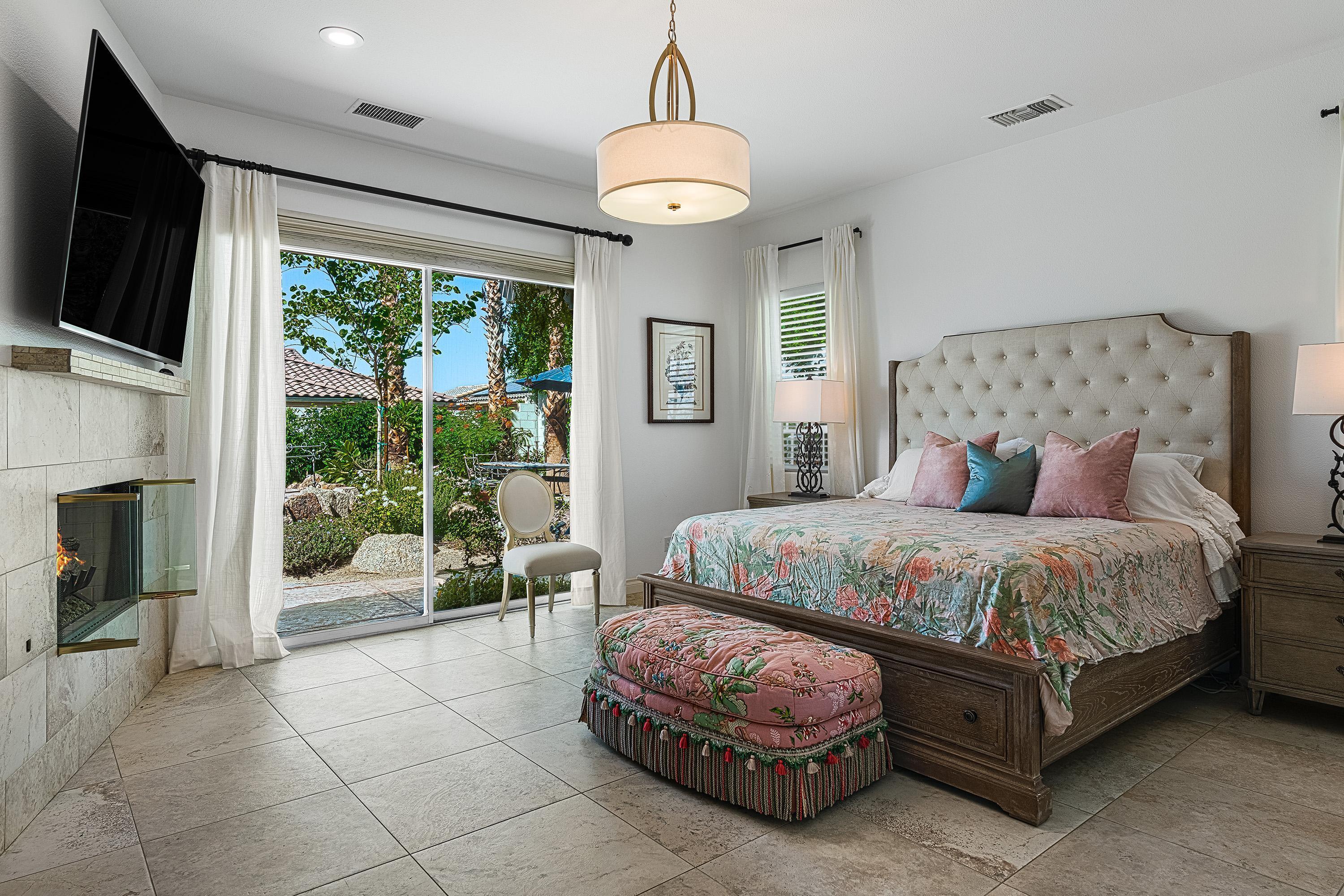 3 Trafalgar Rancho Mirage, CA 92270 - Photo 28 of 42 a spacious bedroom with a bed and glass door