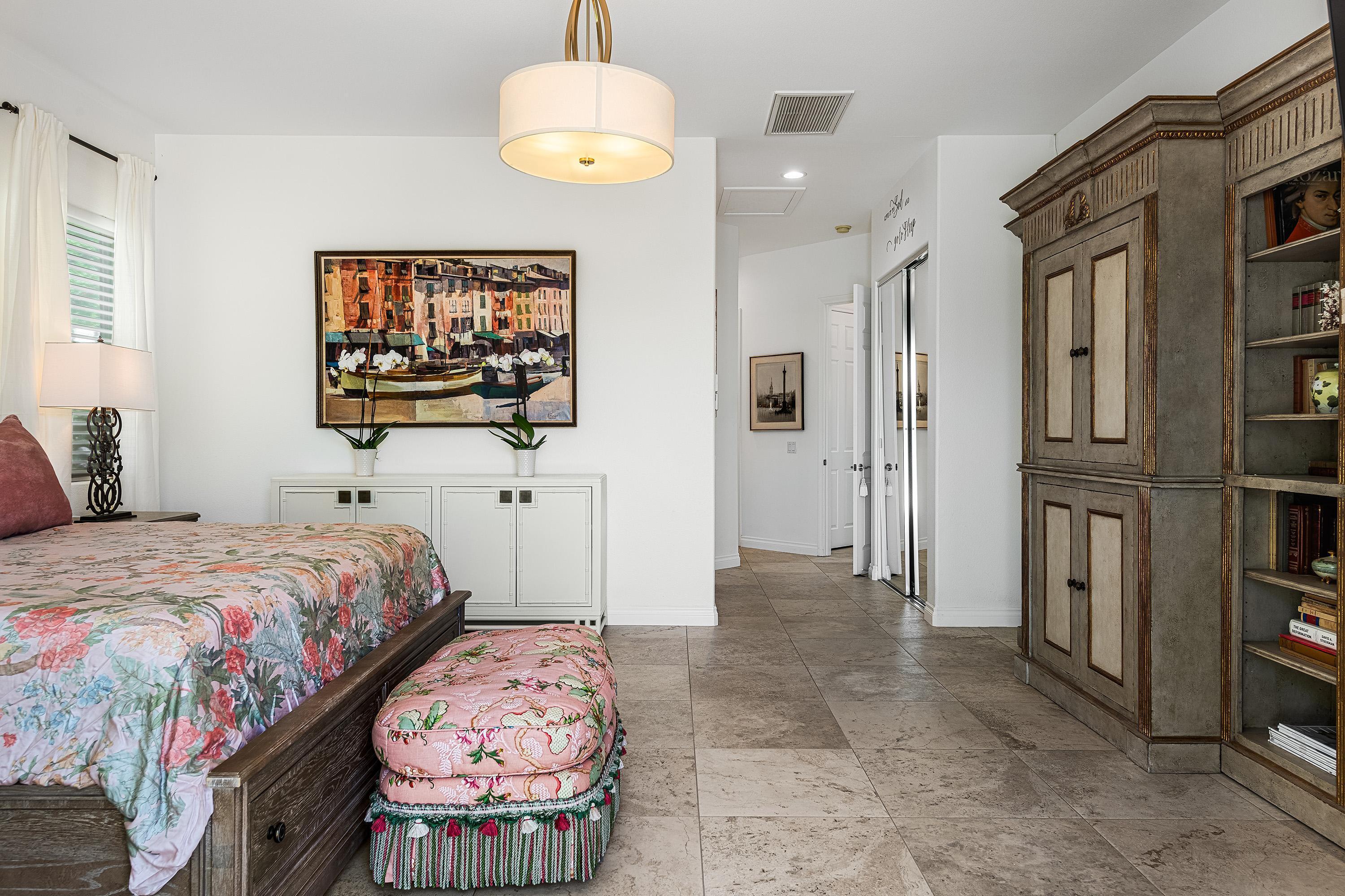 3 Trafalgar Rancho Mirage, CA 92270 - Photo 29 of 42 a bedroom with a bed and a chandelier