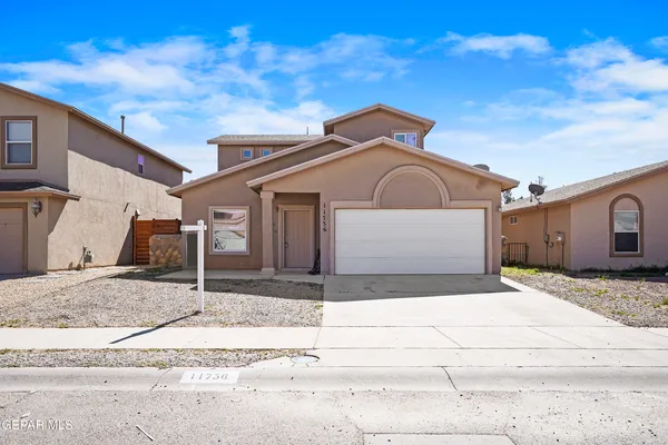 a front view of a house with a garage