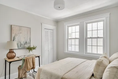 a bedroom with furniture and a window