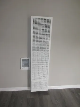 a view of an empty room with wooden floor